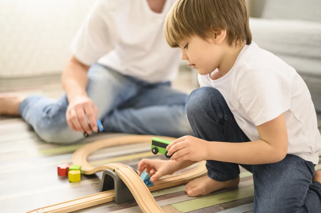 Child Engaged in Playtime with Toy Trains